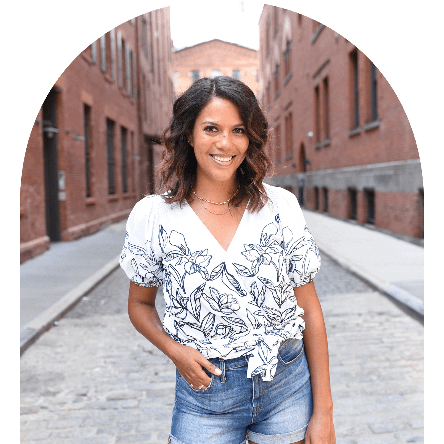 Ali, outside on a cobblestone street.